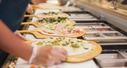 Employee Making Pizzas